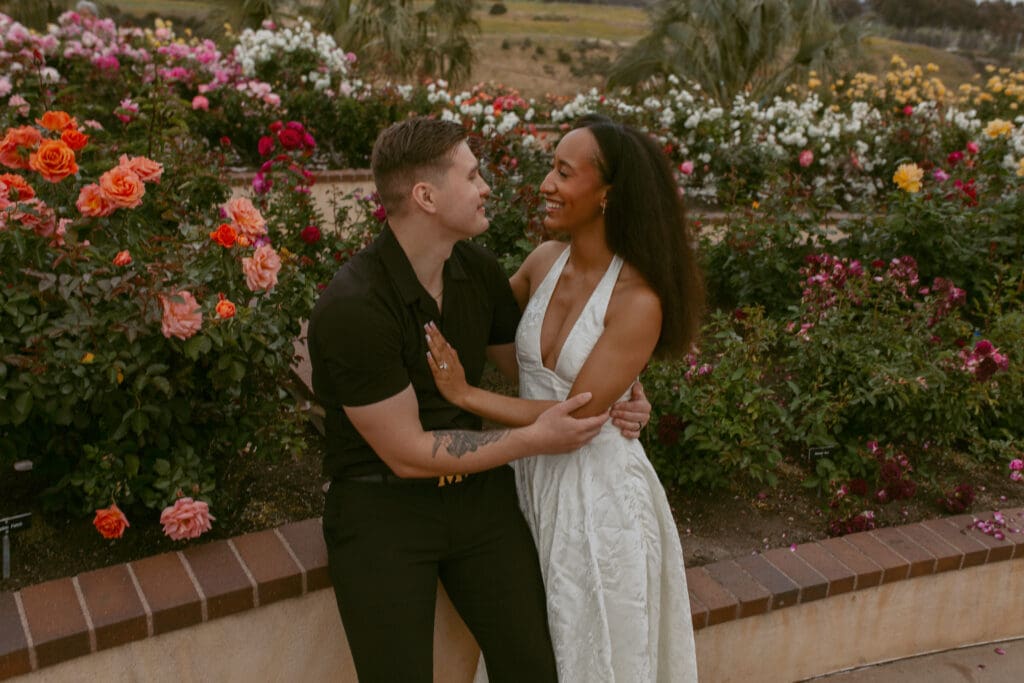 Couple embracing in Rose Gardens at Balboa Park.